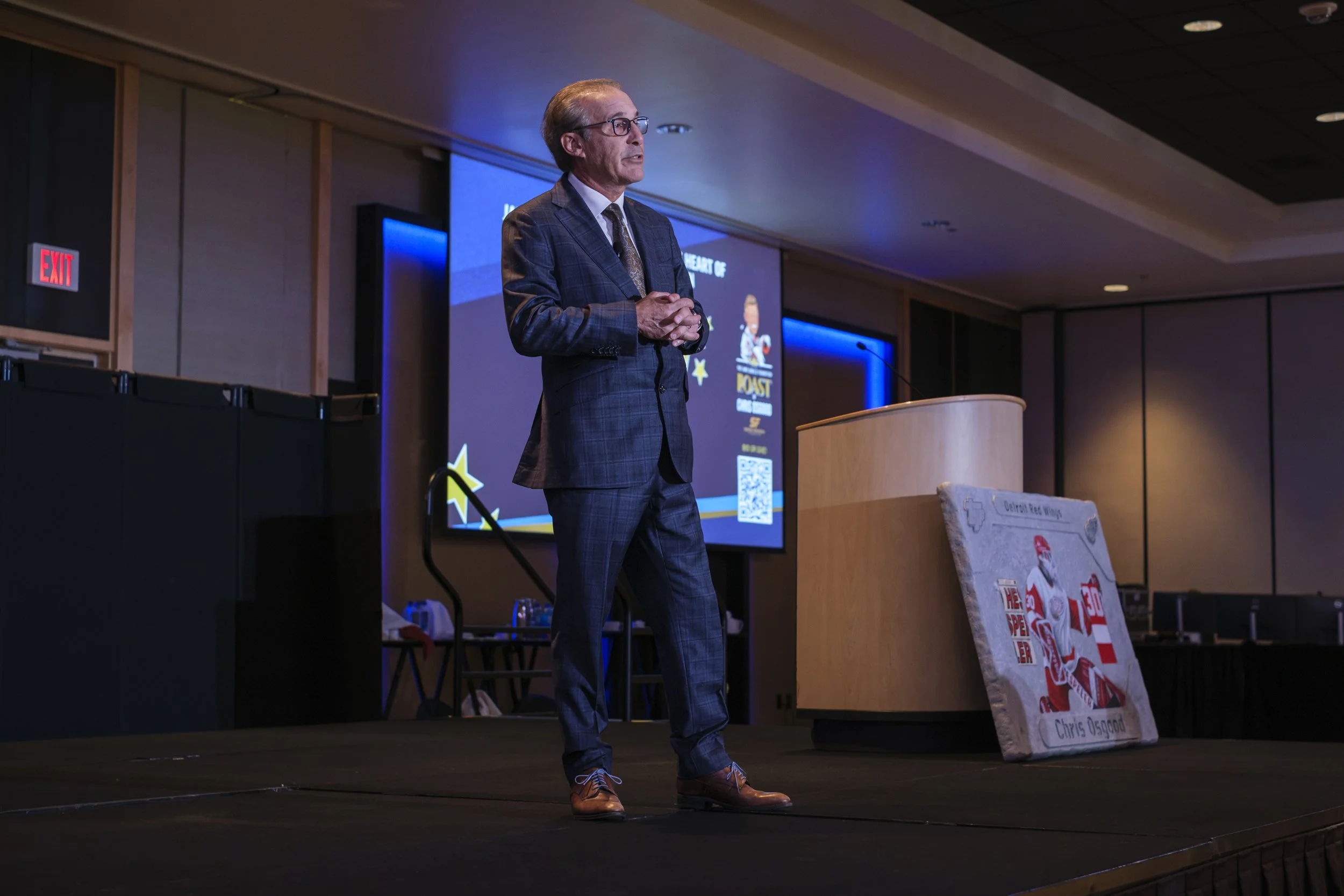 Ken Daniels, Co-founder of the Jamie Daniels Foundation, speaks on a stage during a gala event,