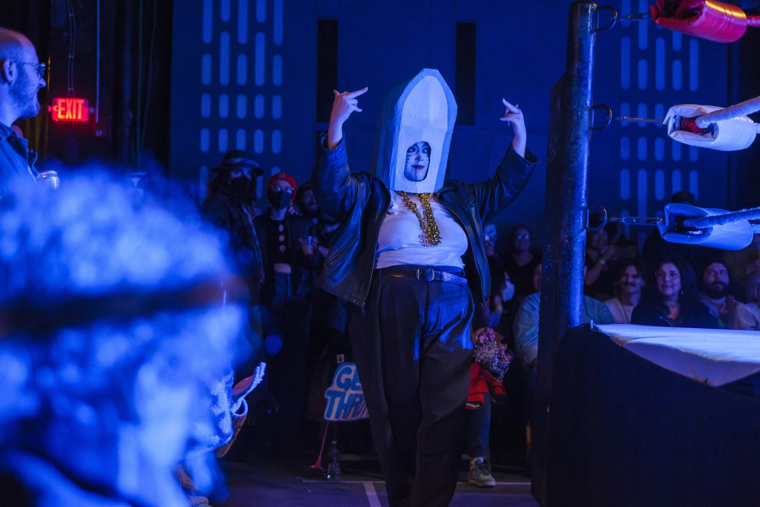 Clown wrestler, known as the Loan Shark, walks around the ring before battling their opponent.