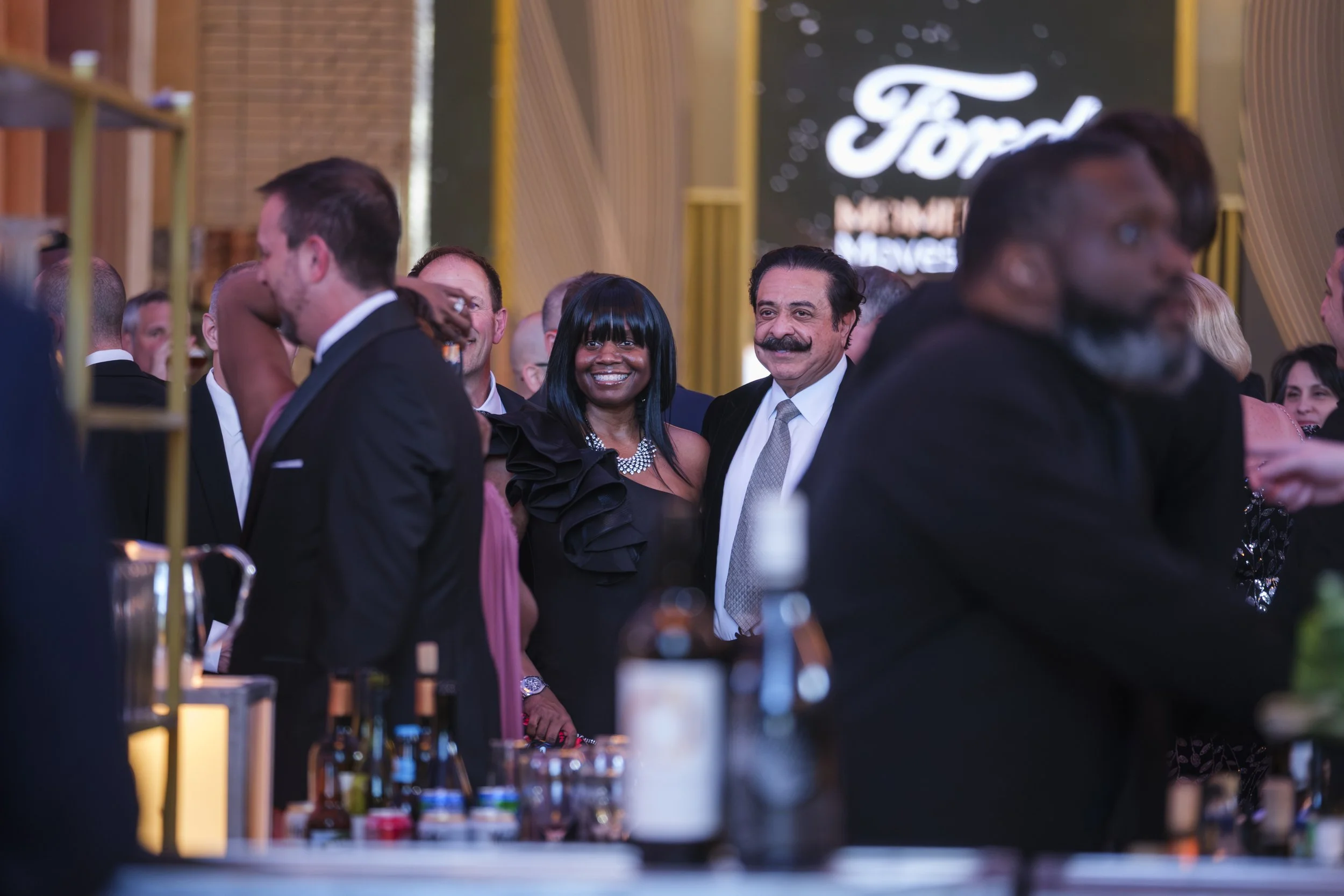 A man and a woman smile while posing for a cell phone photo at the Ford Supplier Summit Awards at Michigan Central Station.