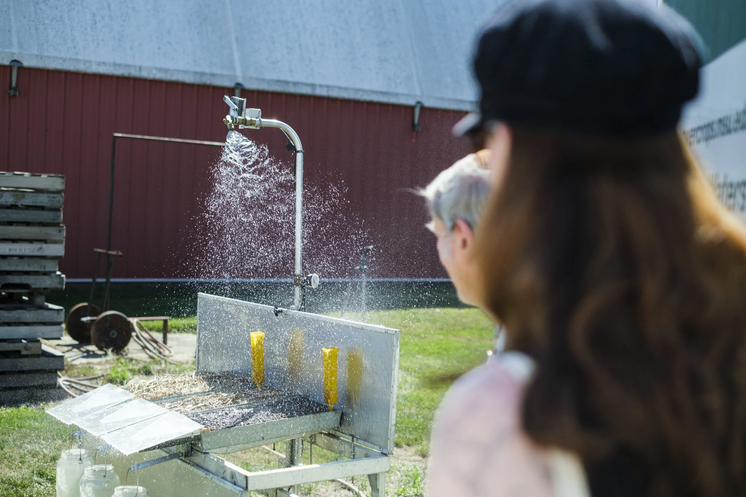 A rainfall simulator sprays water onto soil samples during the Washtenaw County Conservation District's Farmer Field Day.
