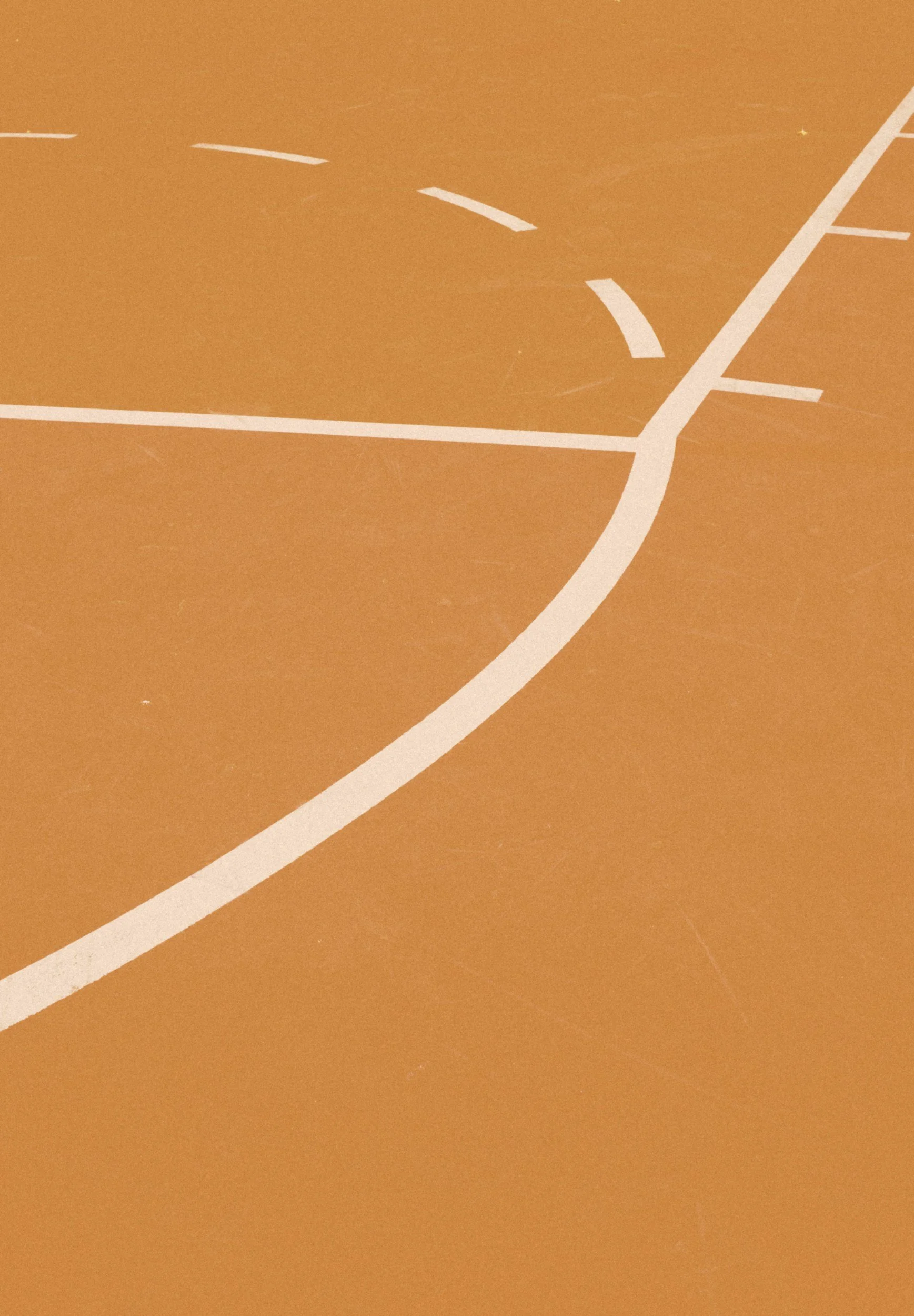 Close-up of an orange sports court surface with white boundary lines and markings for playing basketball or similar sports.