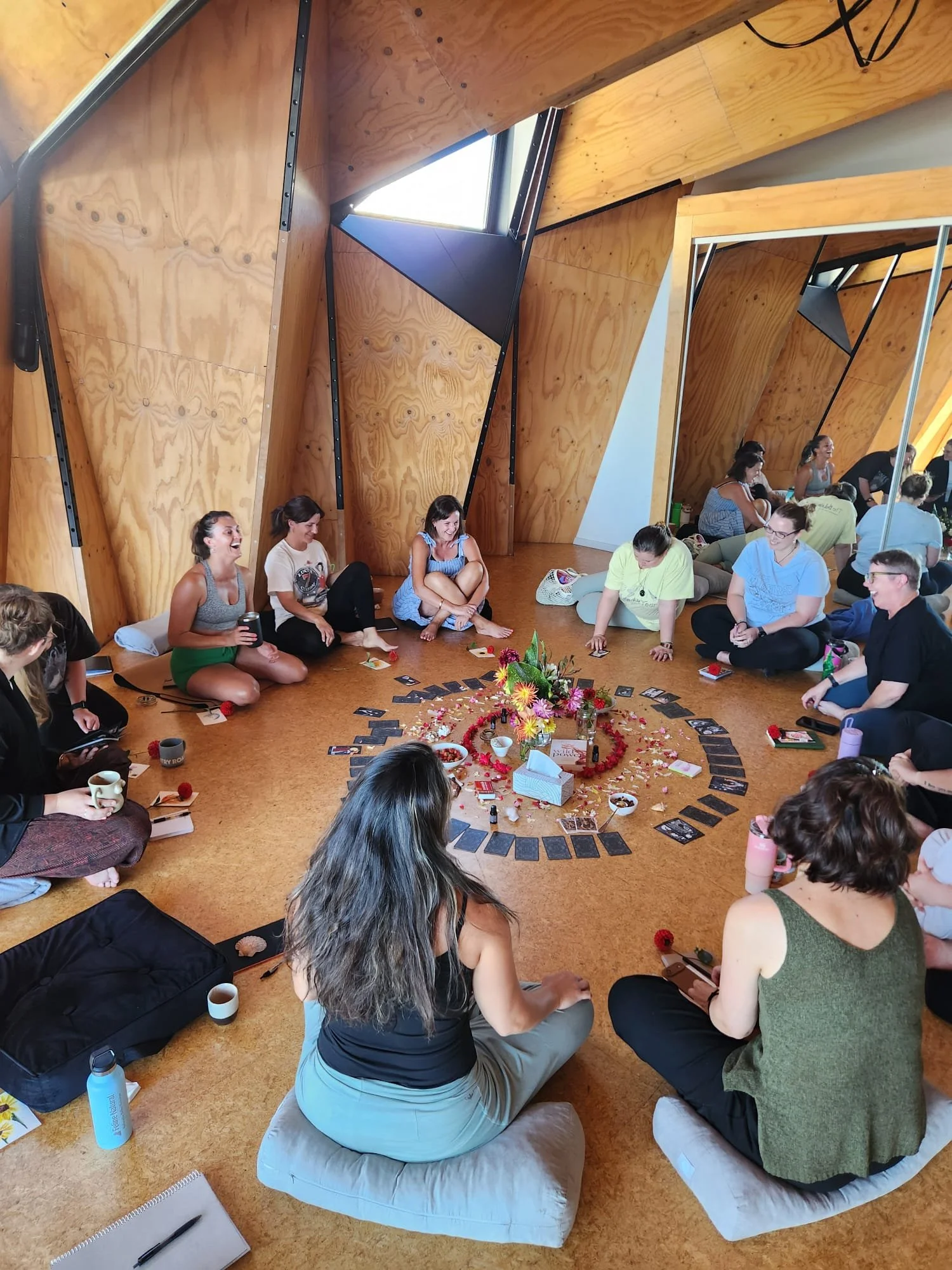 Women sitting together in a circle at an intimate wellness gathering, Christchurch