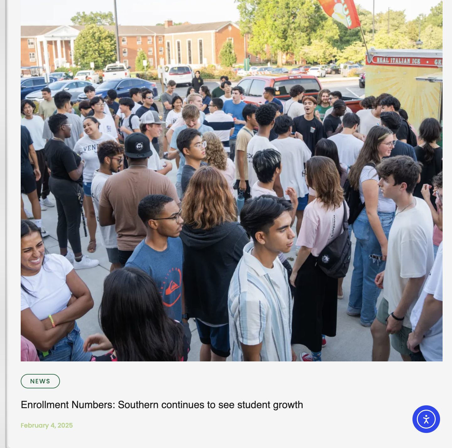 A group of diverse students standing outside on a school campus, some smiling and talking, near parked cars and a building, with a sign indicating they are waiting in line or gathering for an event.