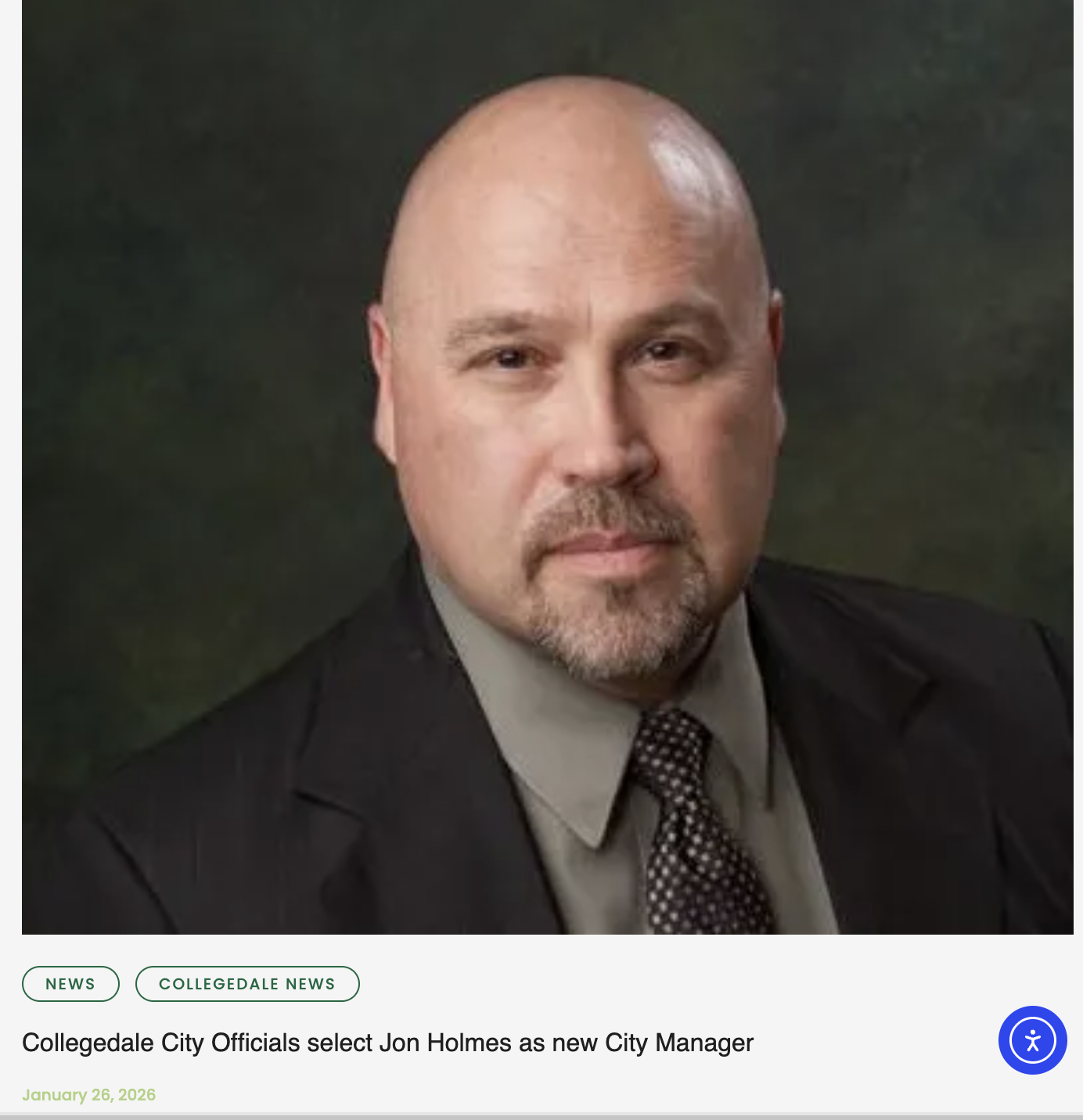 Portrait of Jon Holmes, a bald man with a goatee, wearing a suit and tie, with a dark green textured background. The image accompanies a news article about Jon Holmes being selected as the new City Manager of Collegedale.