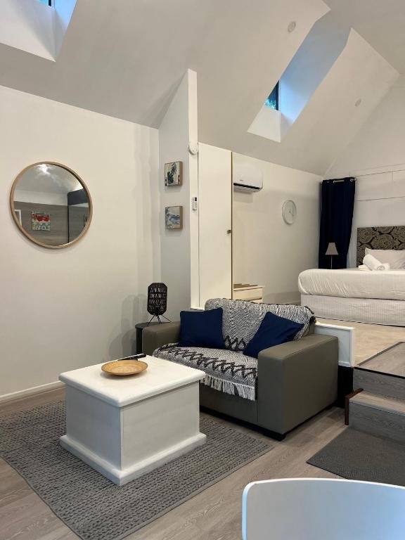 Light-filled chalet interiors create a calm rainforest escape, perfectly positioned for visitors seeking accommodation near Gallery Walk.