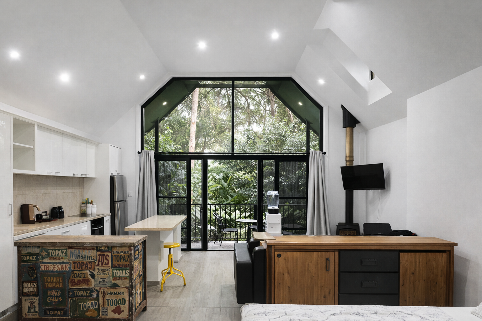 This Tamborine Mountain accommodation features light-filled, open-plan chalets with forest outlooks, private balconies and relaxed interiors designed for a peaceful rainforest stay.