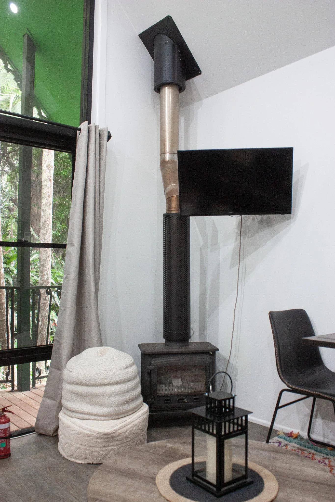 A cosy living space at this Tamborine Mountain accommodation, featuring warm interiors and rainforest surrounds, ideal for a relaxing getaway near Gallery Walk.