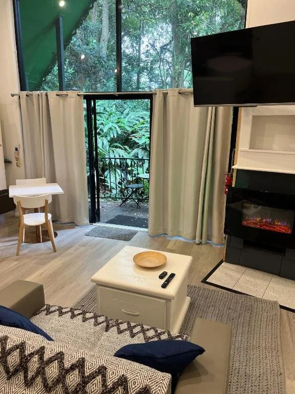 Private balconies and forest outlooks enhance the relaxed feel of these chalets, offering a true rainforest stay on Tamborine Mountain.