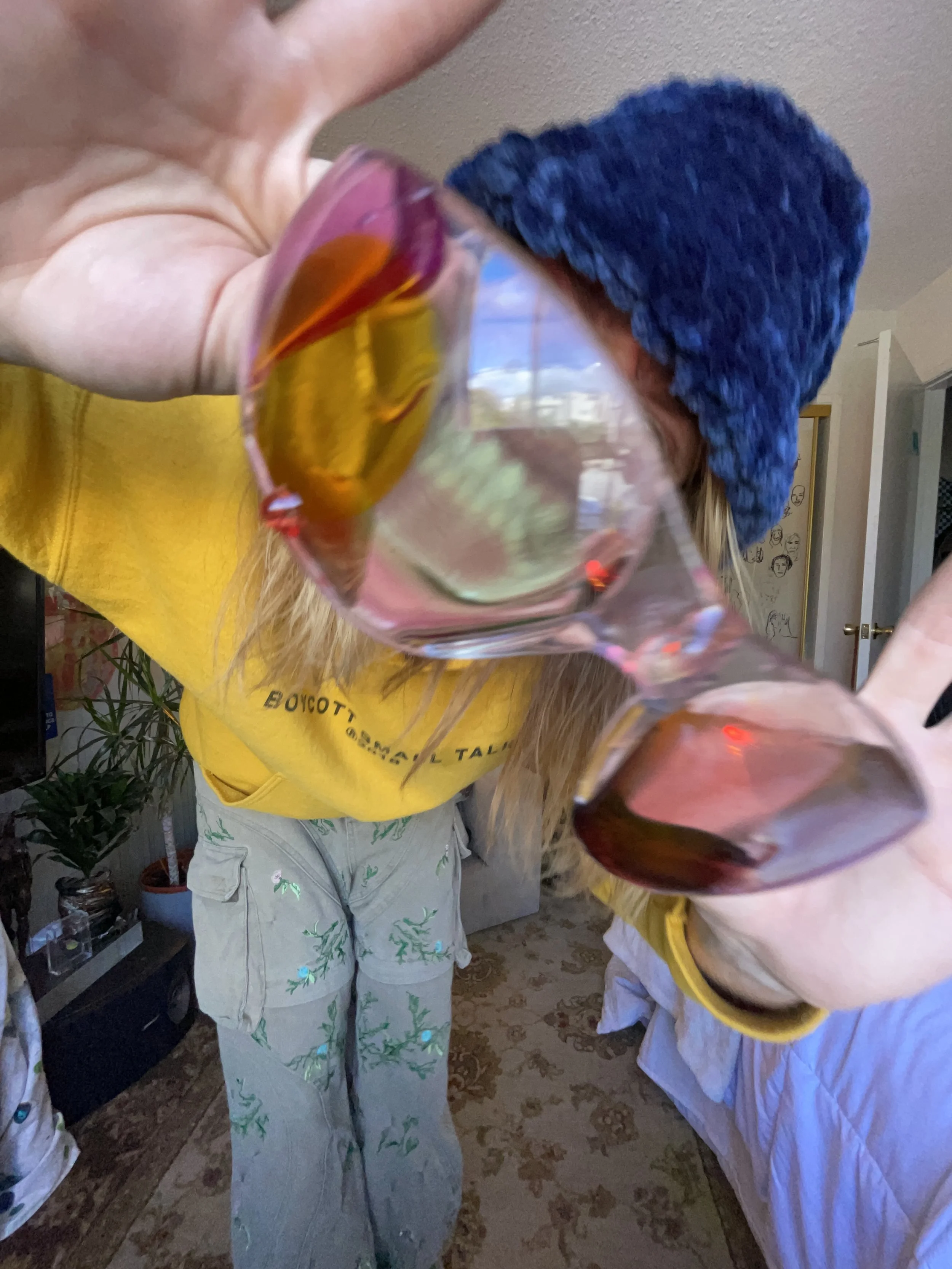 Kendall Cleveland holding custom resin glasses at the camera and smiling