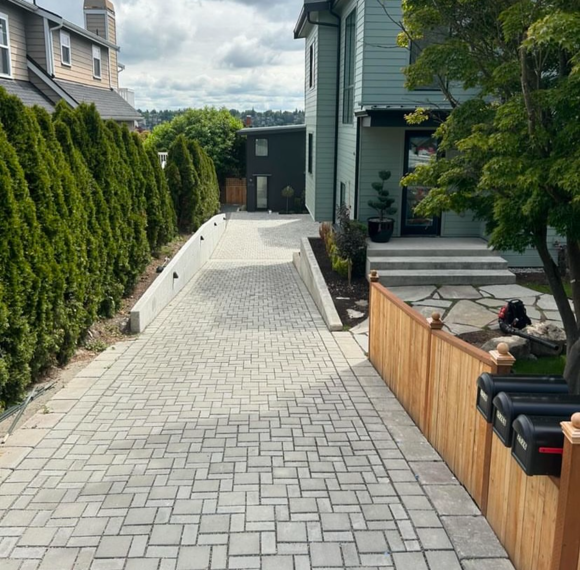 An image of a completed driveway and landscape installation.