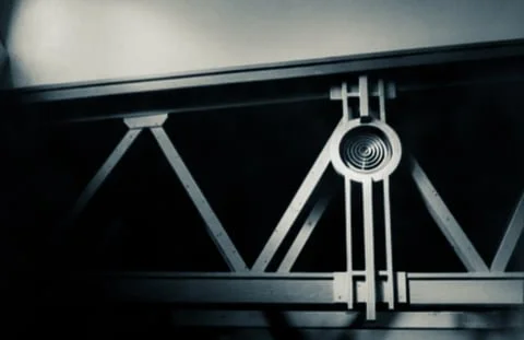 Close-up of a metal bridge construction with supporting beams and a mechanical component.