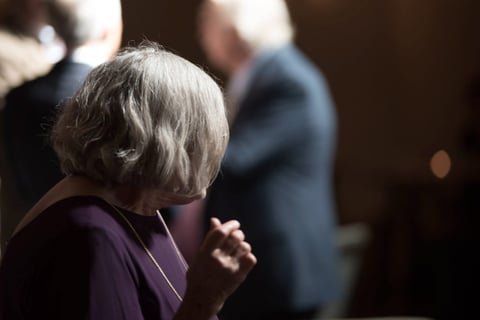 a cinematic style of old woman looking way