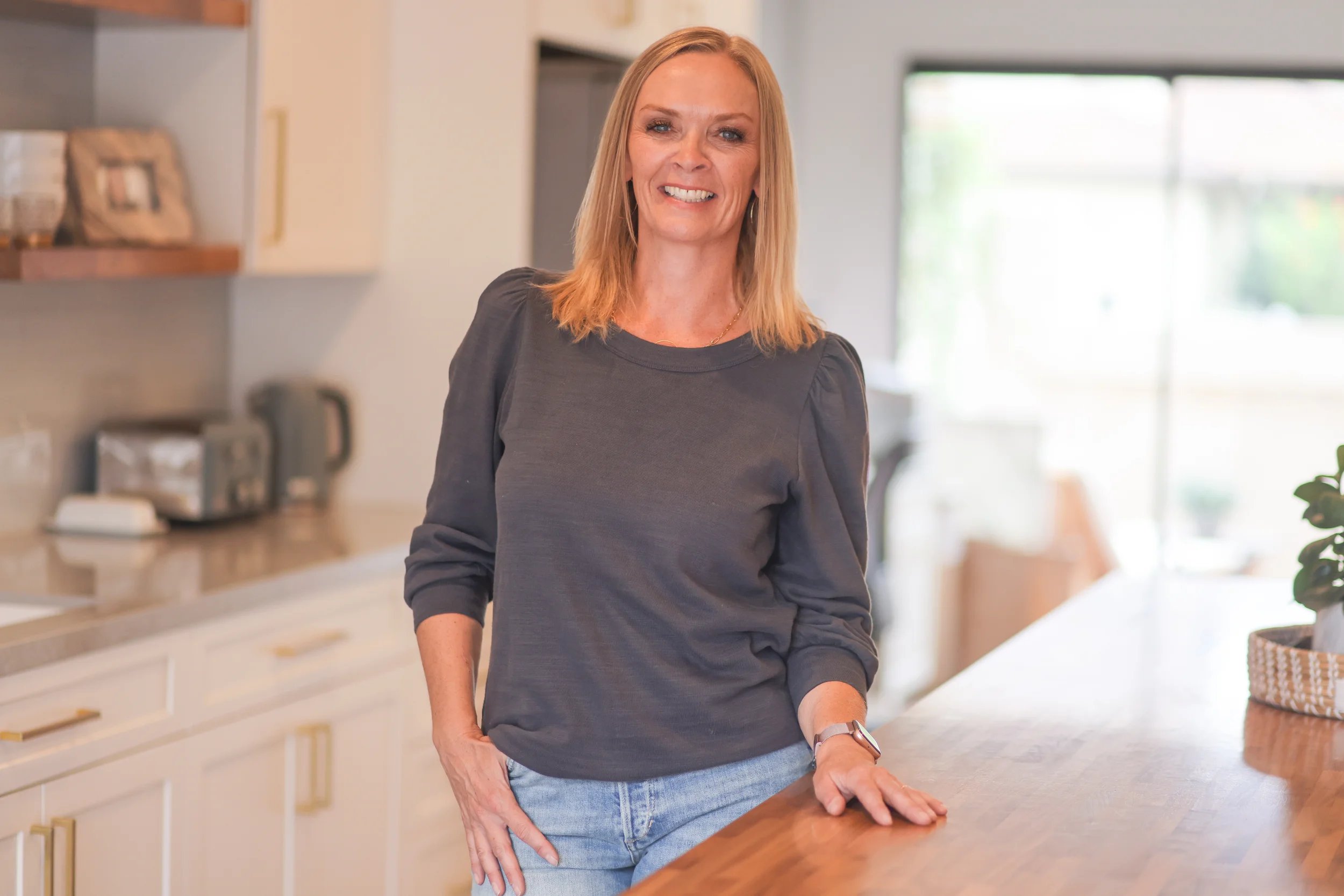Vicki Rawson of North County Concierge standing in a client’s organized kitchen.