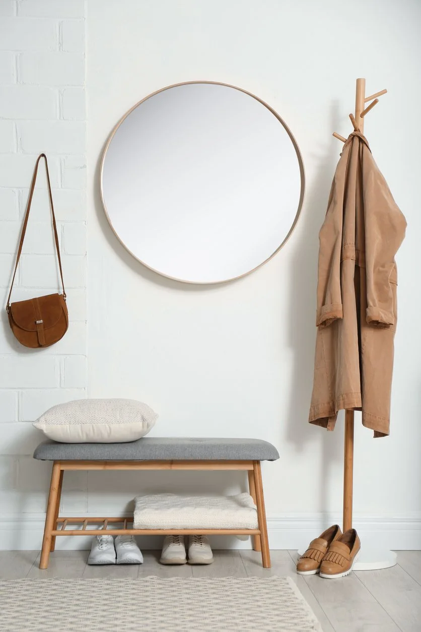 Calm and organized entryway with bench seating, wall hooks, and space for shoes and everyday essentials, creating a functional drop zone.