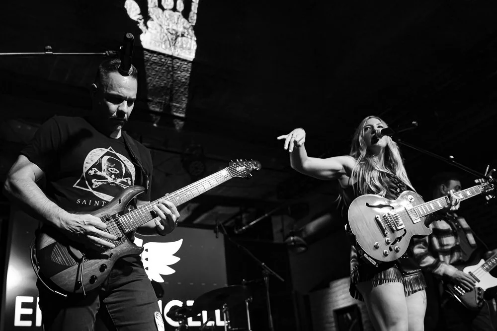 Black and white; Emilyxliam on stage holding guitars in Port Chester, NY