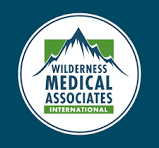 Logo for Wilderness Medical Associates International featuring a mountain and green landscape.