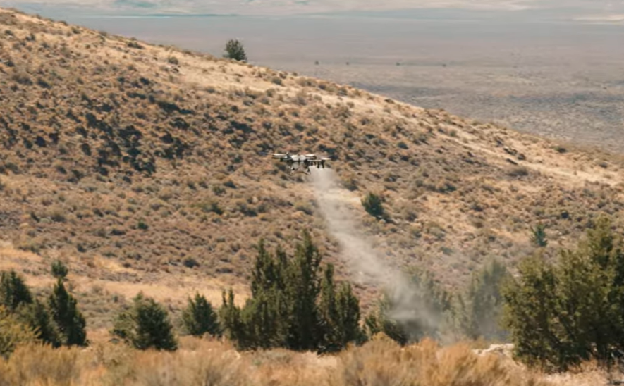 Agriculture drone spraying over rough terrain
