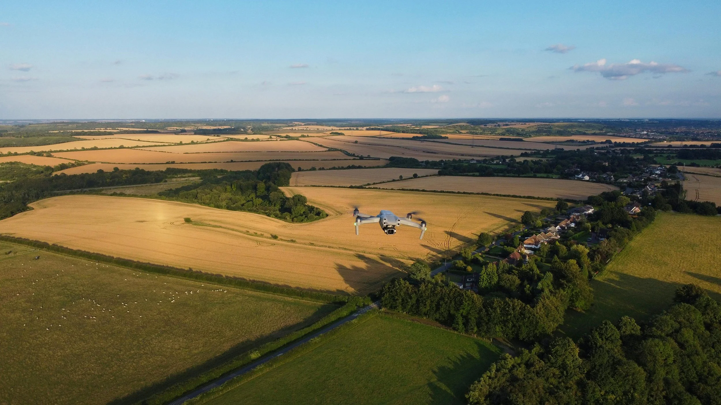 Agricultural drone flying over farm fields for crop monitoring