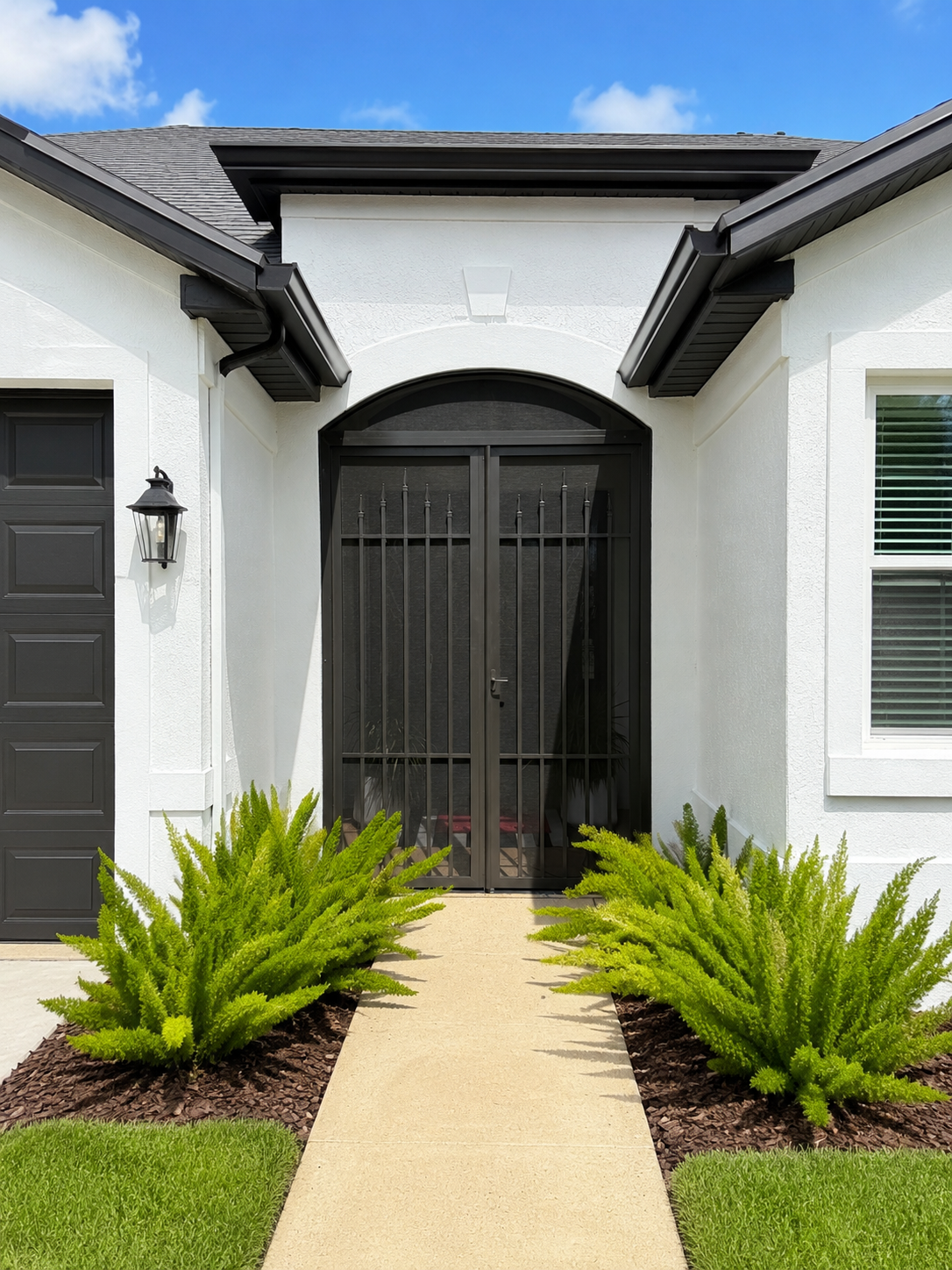 Modern house entrance with lush landscaping.png