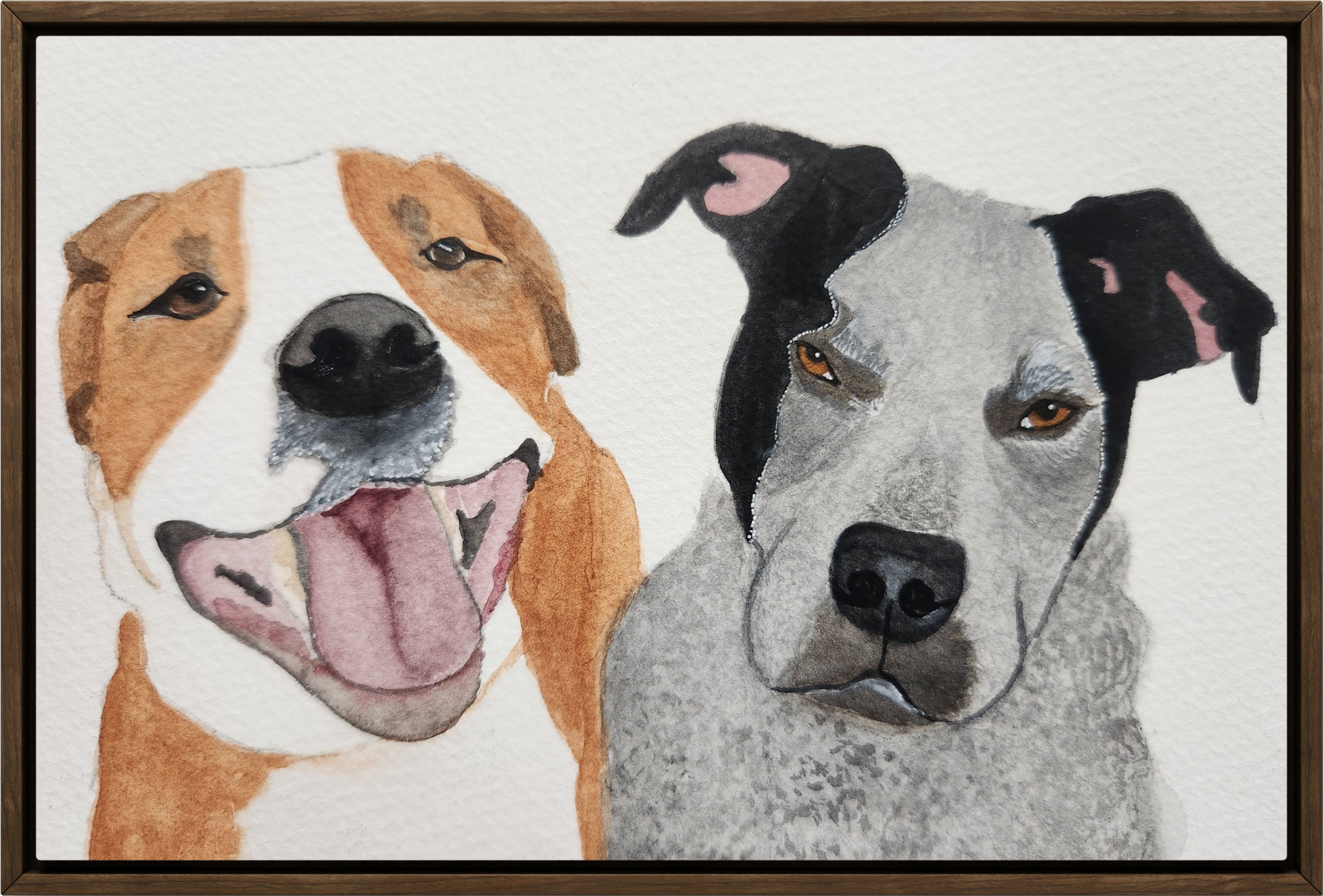Watercolor painting of two dogs, one with a happy expression and the other with a serious look, framed in a wooden border.