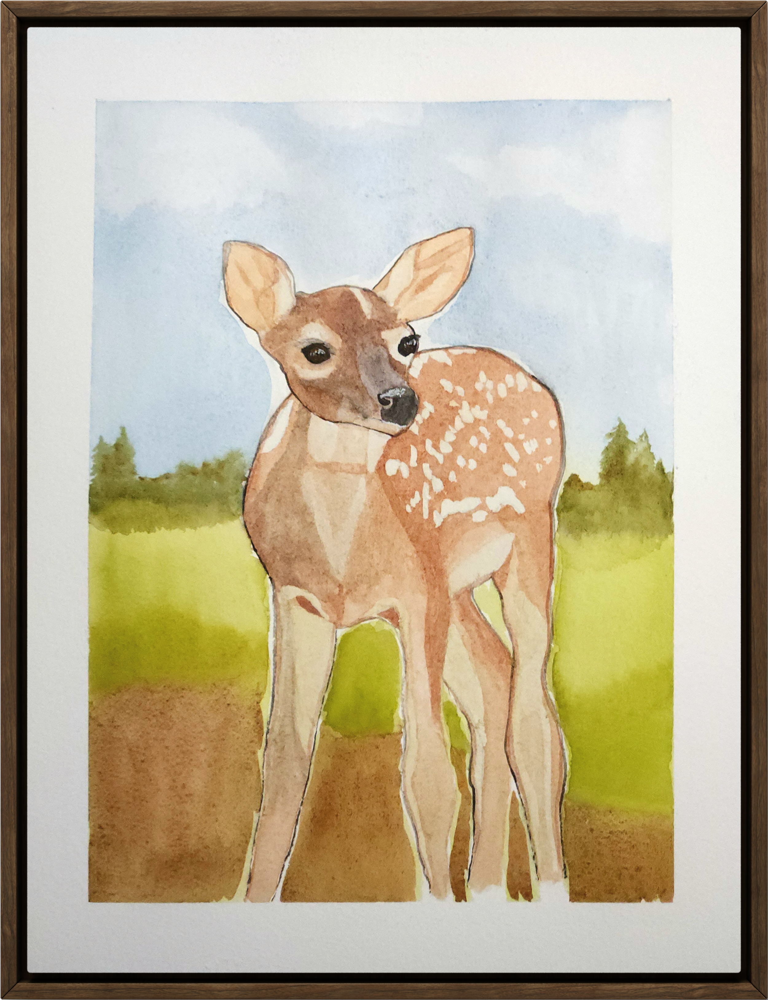 Watercolor painting of a young deer standing outdoors on a grassy field with a blue sky and distant trees in the background.