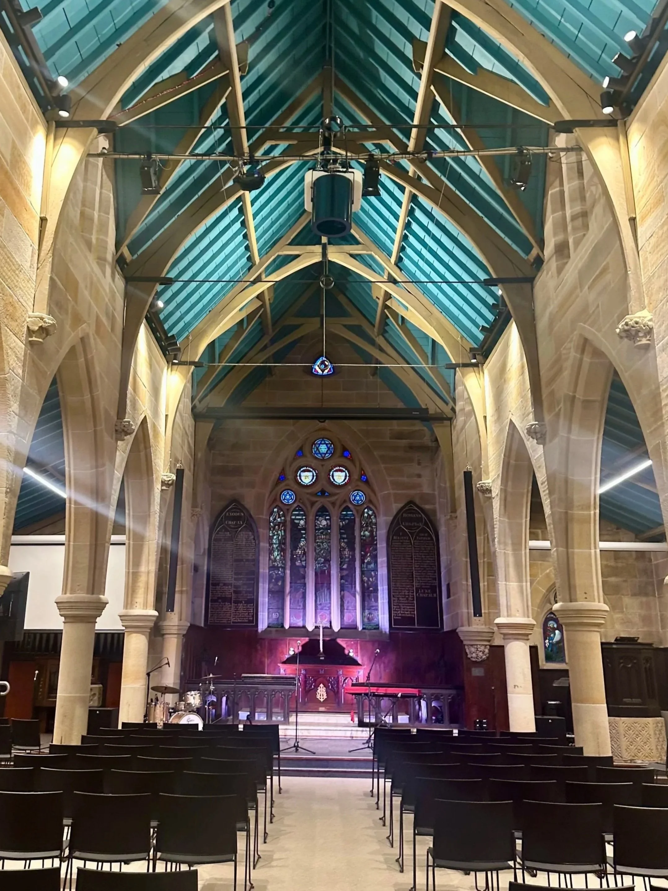Historic Sydney church interior showcasing vaulted ceilings and stained glass prior to wedding floral installation
