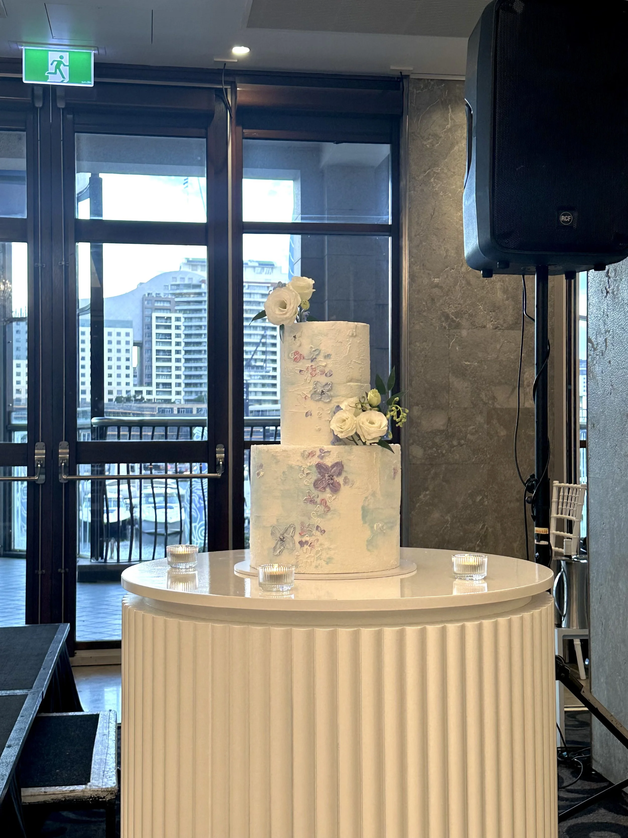 Two tier pastel wedding cake styled to complement architectural lines and soft floral design at a Sydney venue