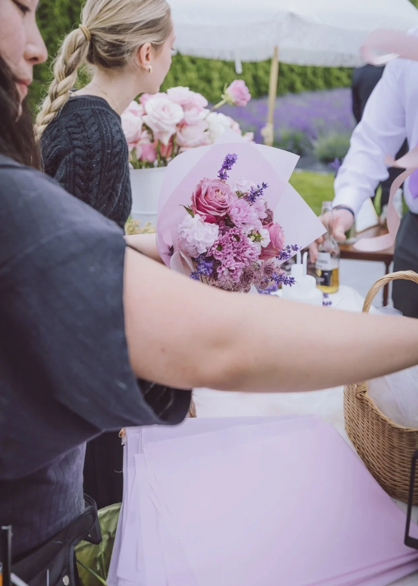 Hand-tying and wrapping a custom bouquet during a Bloom Bar floral experience.