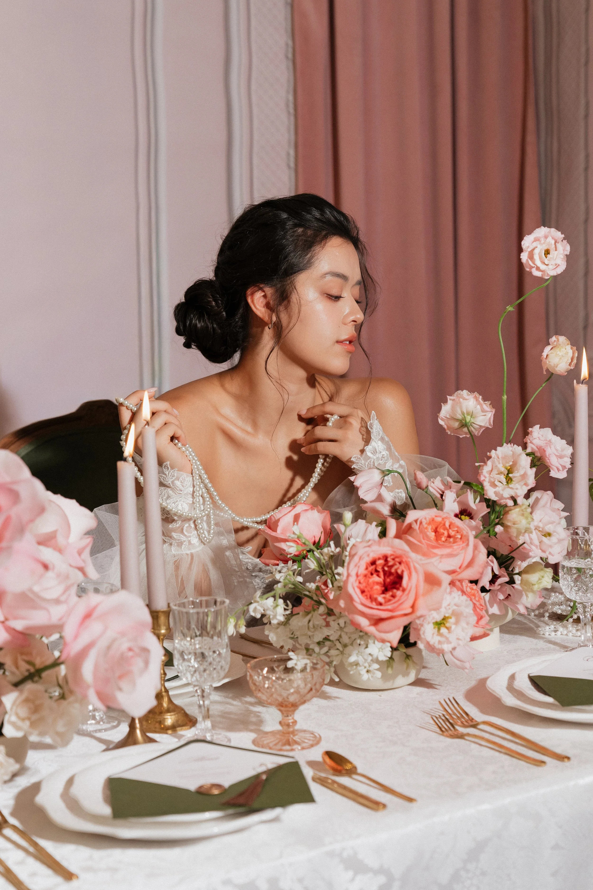 Romantic wedding tablescape featuring garden roses, seasonal flowers, candlelight, and elegant bridal styling.