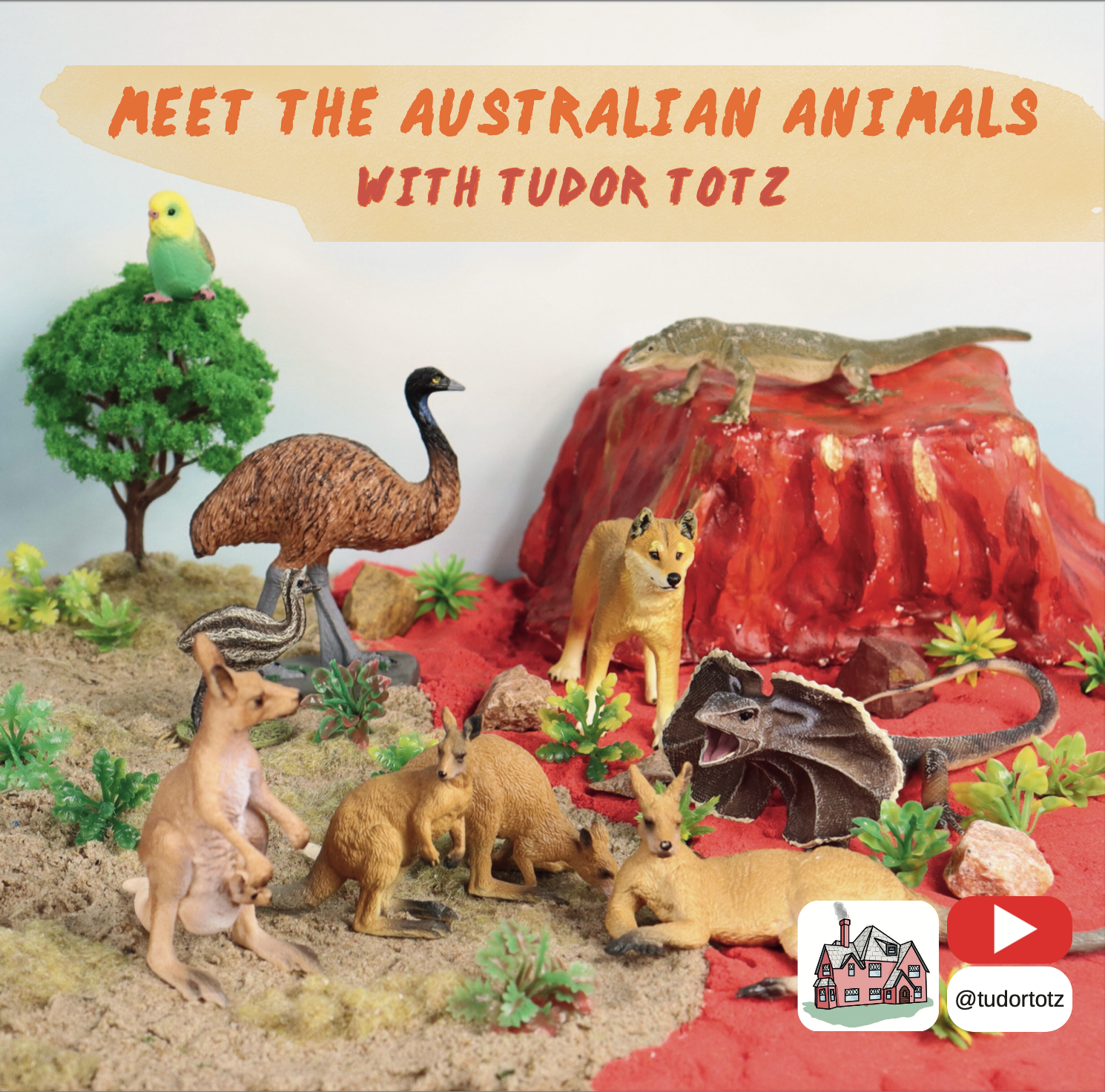 Toy Australian animal figures arranged on a miniature diorama landscape with a red dessert, green plants, and a tree. Text overlay reads 'Meet the Australian animals with Tudor Totz'.  Featuring dingos, filled lizards, kangaroos, koalas and emus.
