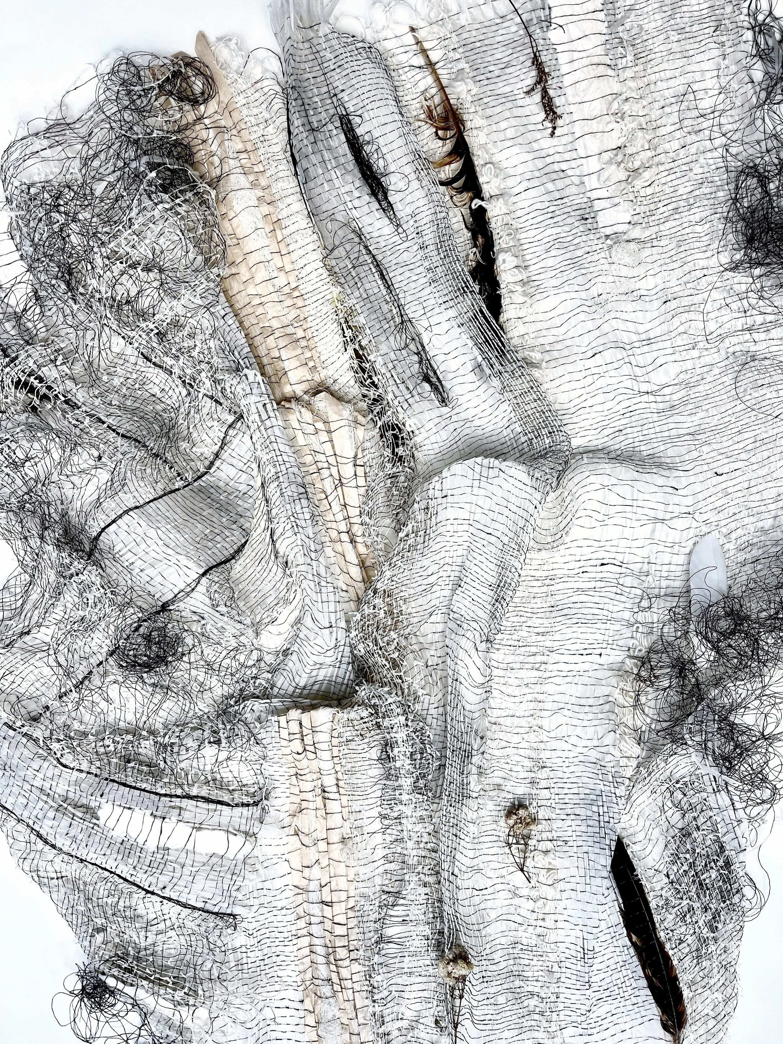 Complex hand woven open weave cloth made from extreme combinations of natural fibres including feathers, silk, steel, and paper.