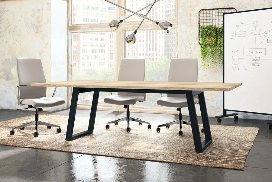 Modern conference room with a rectangular wooden table, three white office chairs, a whiteboard with diagrams, large windows with city view, and a rug on the floor.