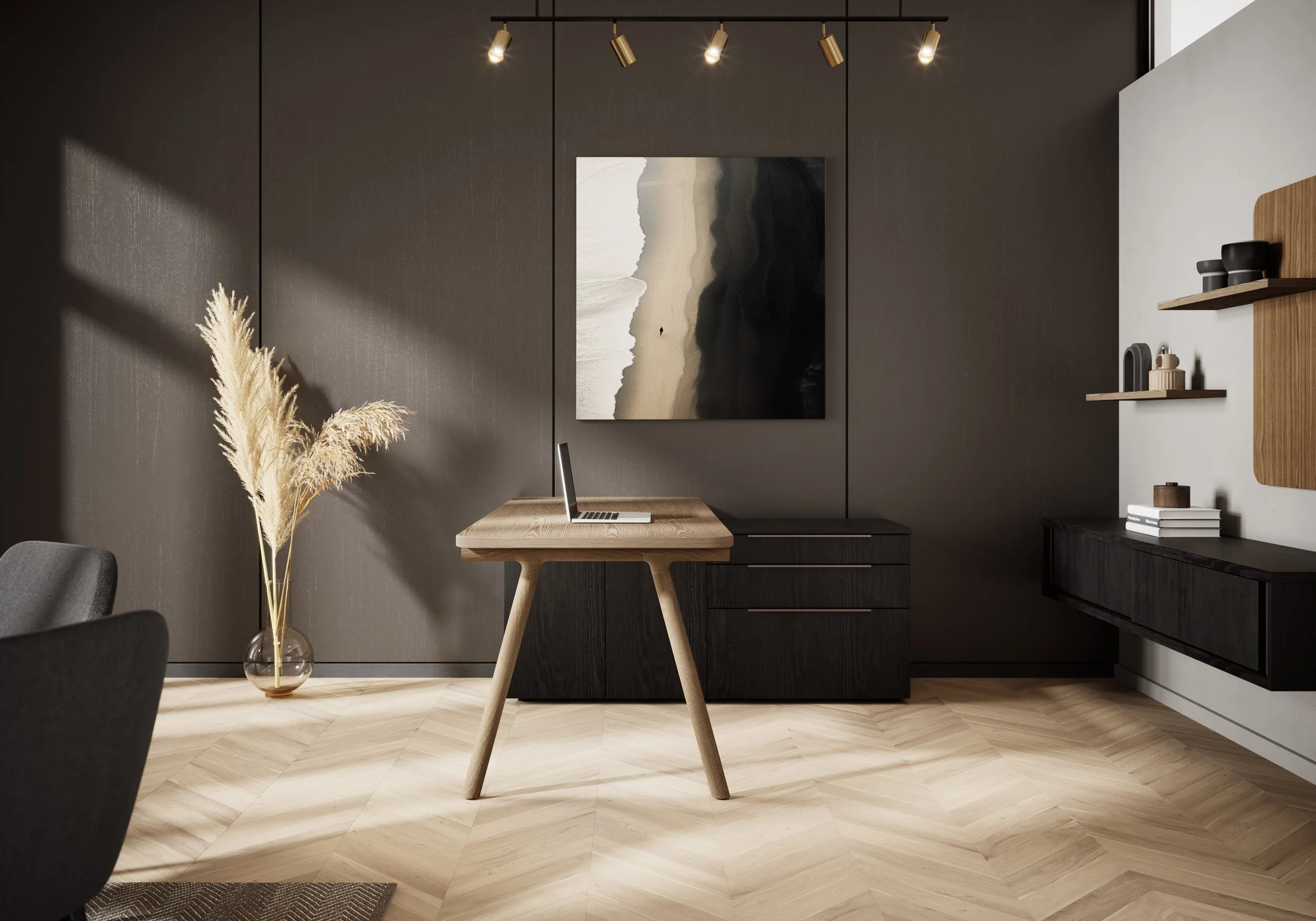 Modern home office with a dark wall, a wooden desk with a laptop, abstract artwork on the wall, a light wood and dark storage cabinet, shelves with decor, and a vase with pampas grass on the floor.