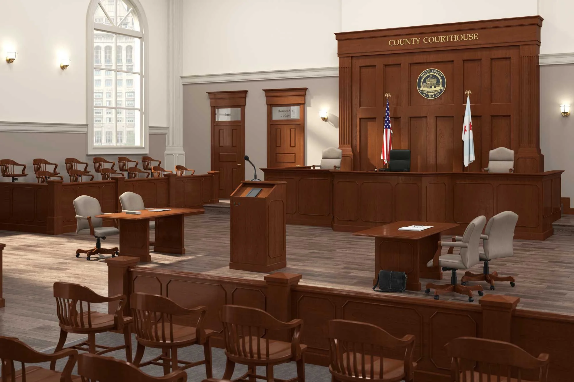 Empty county courtroom with wooden judge's bench, flags, court chairs, and a central podium