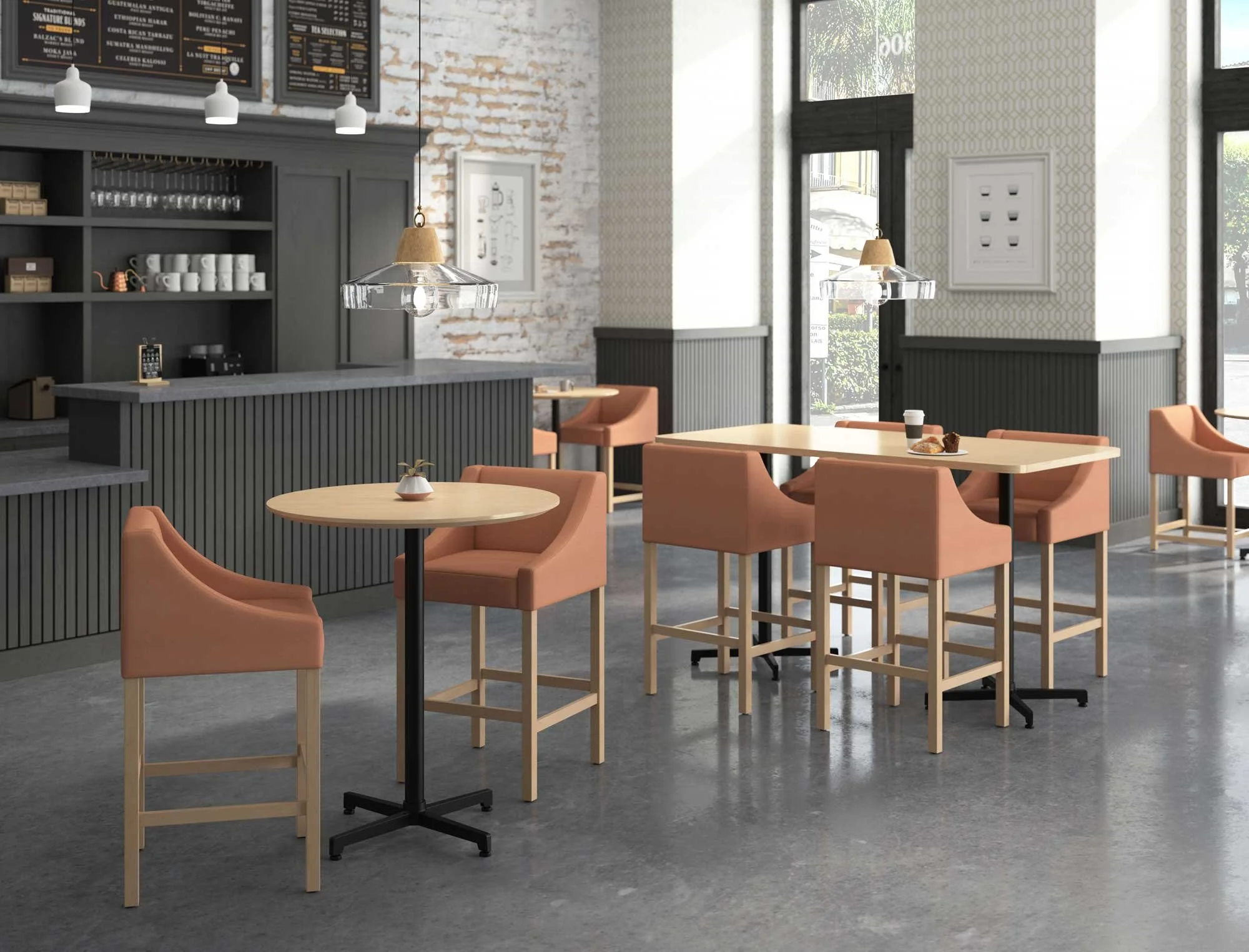 Modern cafe interior with light wood tables, pink cushioned chairs, and black pendant lights. The background features a bar counter with shelves, coffee cups, and a menu board, along with large windows allowing natural light.