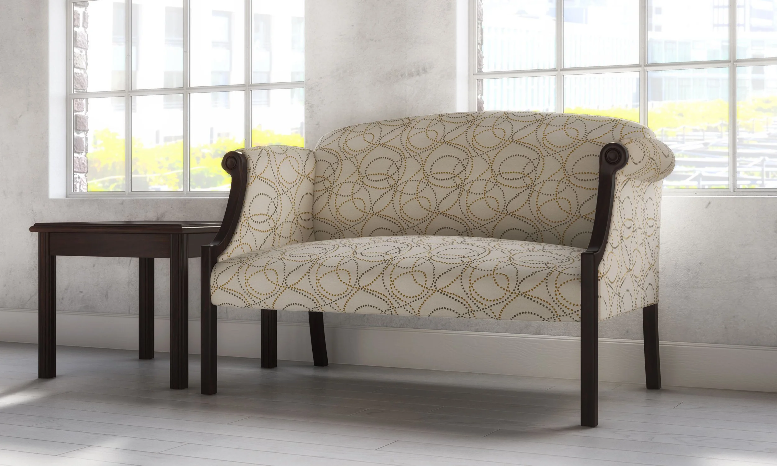 A cream-colored antique-style loveseat with a geometric pattern, dark wooden frame, and curved armrests, positioned next to a small dark wooden side table in front of large windows.