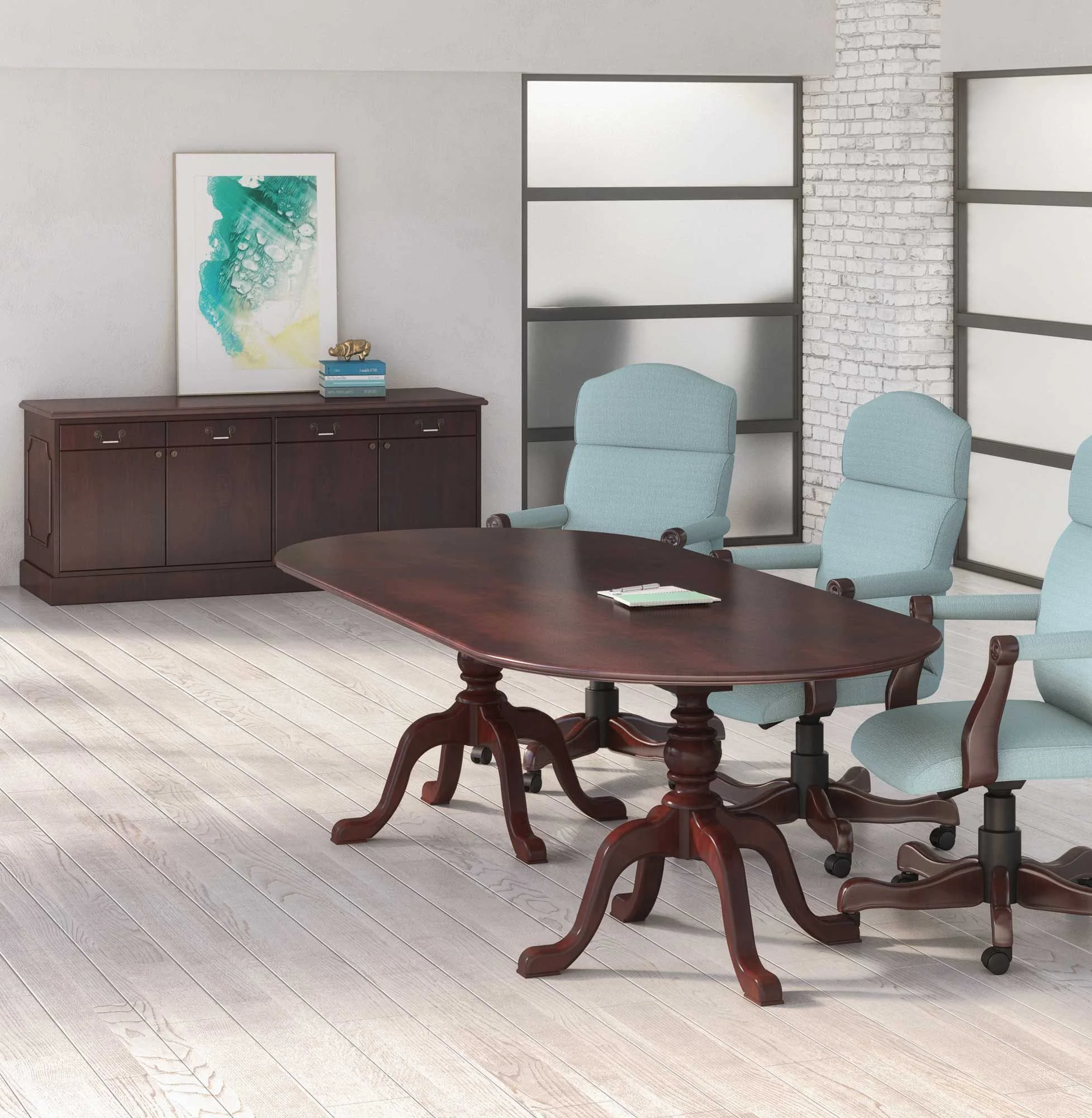 A modern conference room with a wooden table and four light blue office chairs, a dark wooden sideboard with a framed abstract artwork, a small stack of books, and a decorative item, with frosted glass windows and a white brick wall.