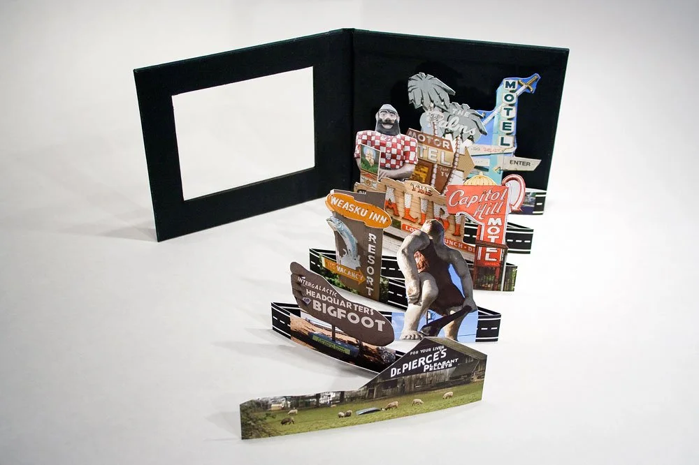 Pop-up book with Oregon neon signs and roadside Americana.