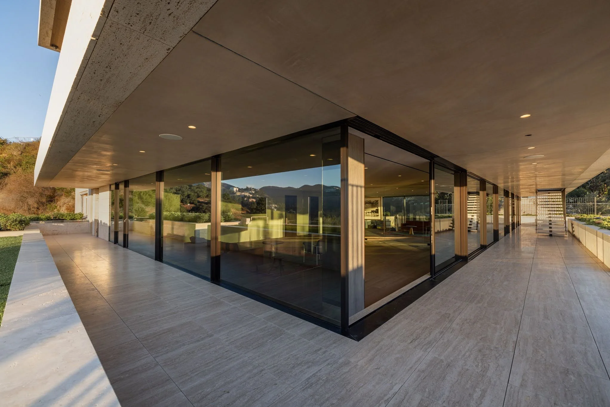 Modern building with large glass windows and a spacious outdoor patio area