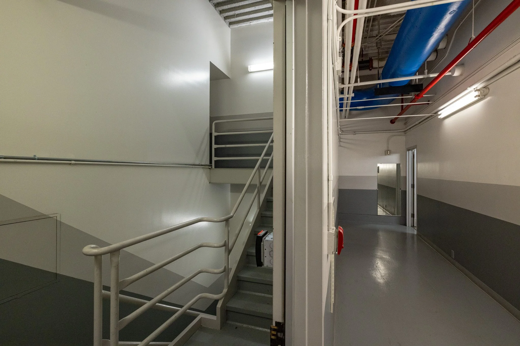 Side-by-side images of staircases and hallways in a building, showing industrial-style corridors with pipes and utilities.