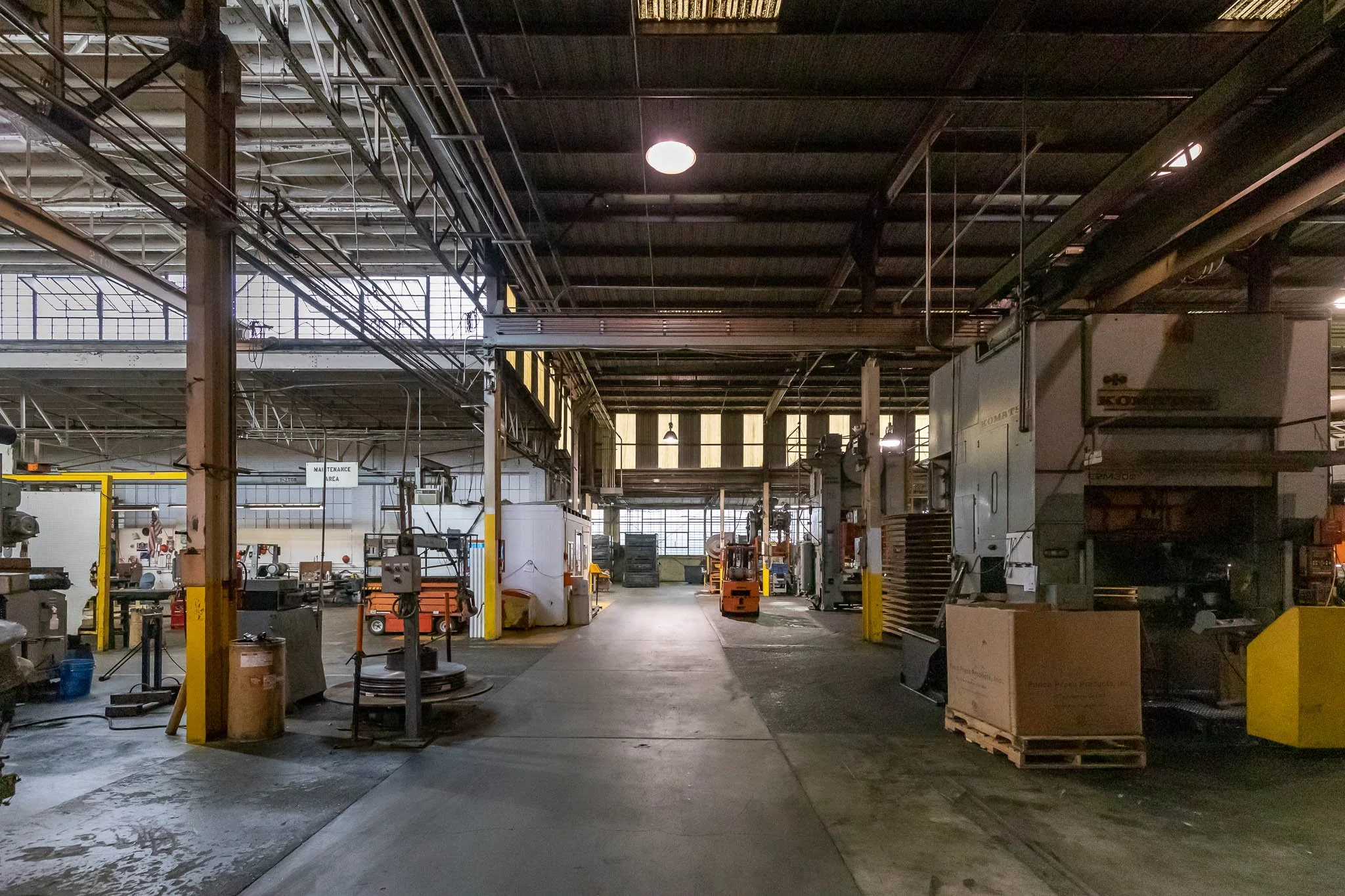 Industrial factory interior with machinery and equipment for manufacturing or maintenance.