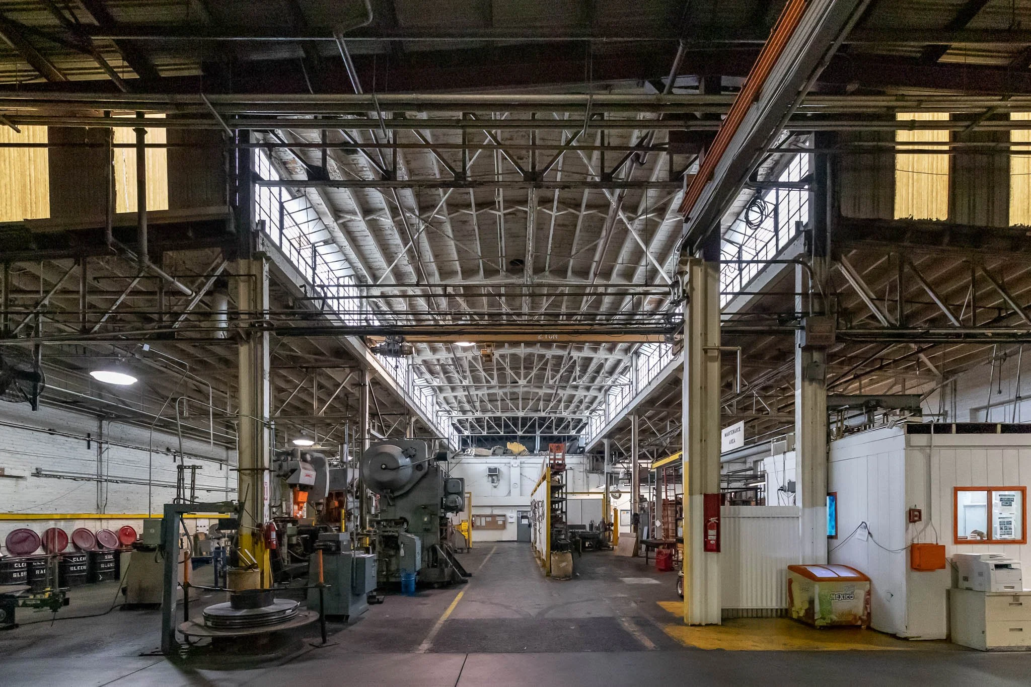 Industrial warehouse interior with machinery, equipment, and storage areas.