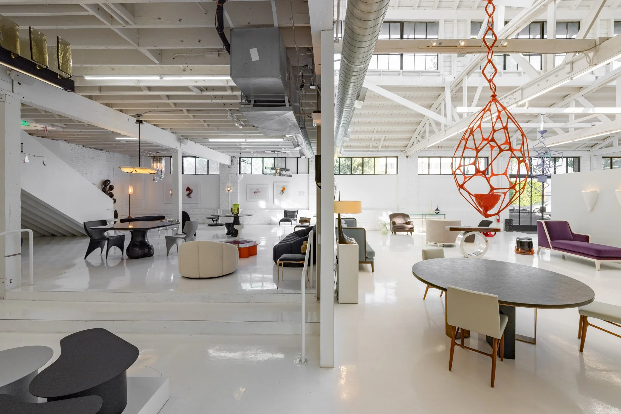 Modern, spacious interior showroom with contemporary furniture and large skylights.