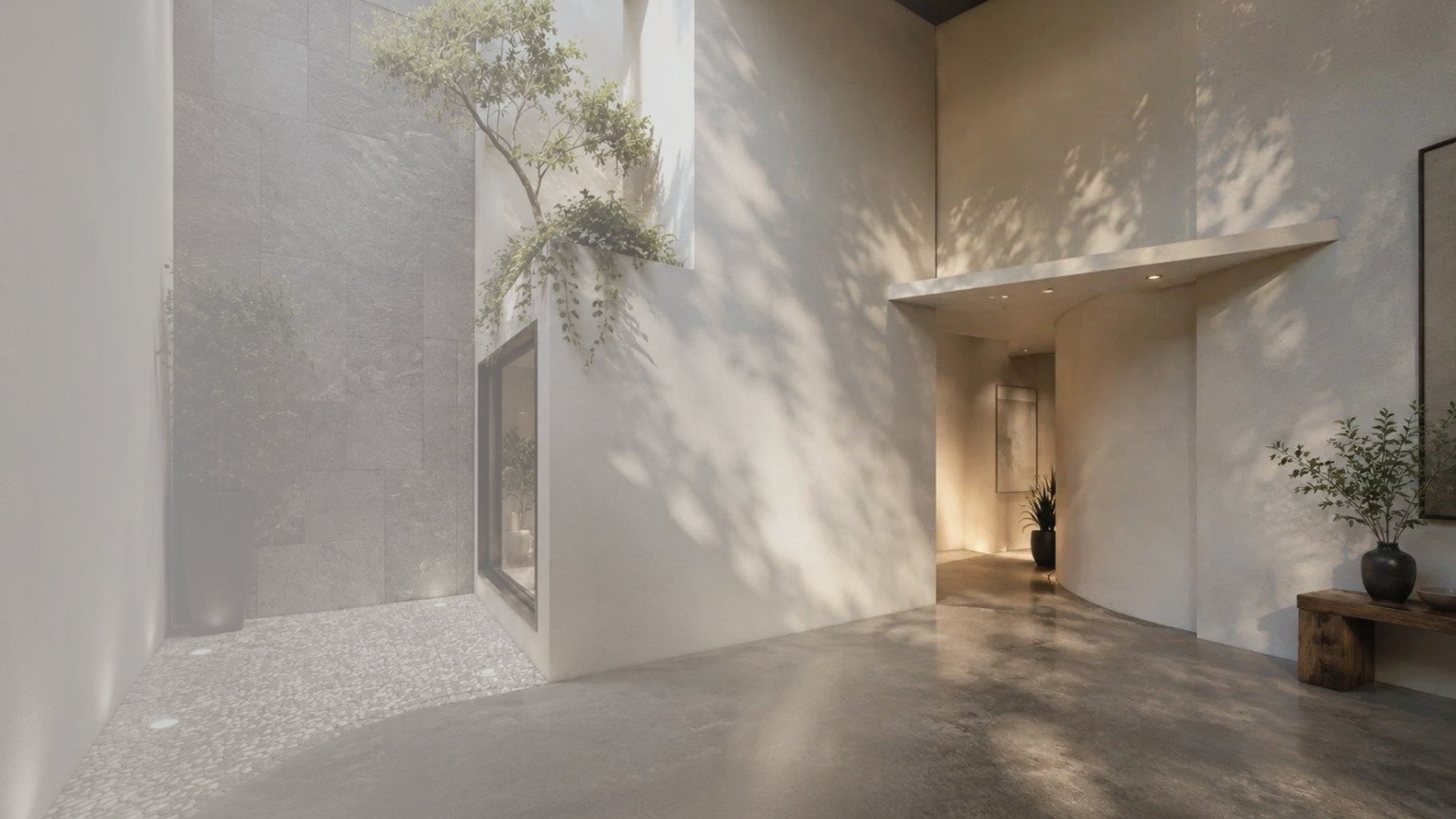 Modern interior space with concrete floor, white and gray walls, natural light, potted plants, and minimal decor.
