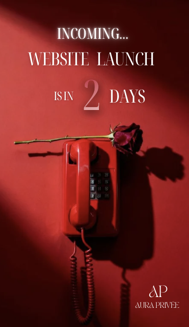 Red telephone on red background with a red rose on top, predicting website launch in 2 days, with text and logo of Aura Privée.
