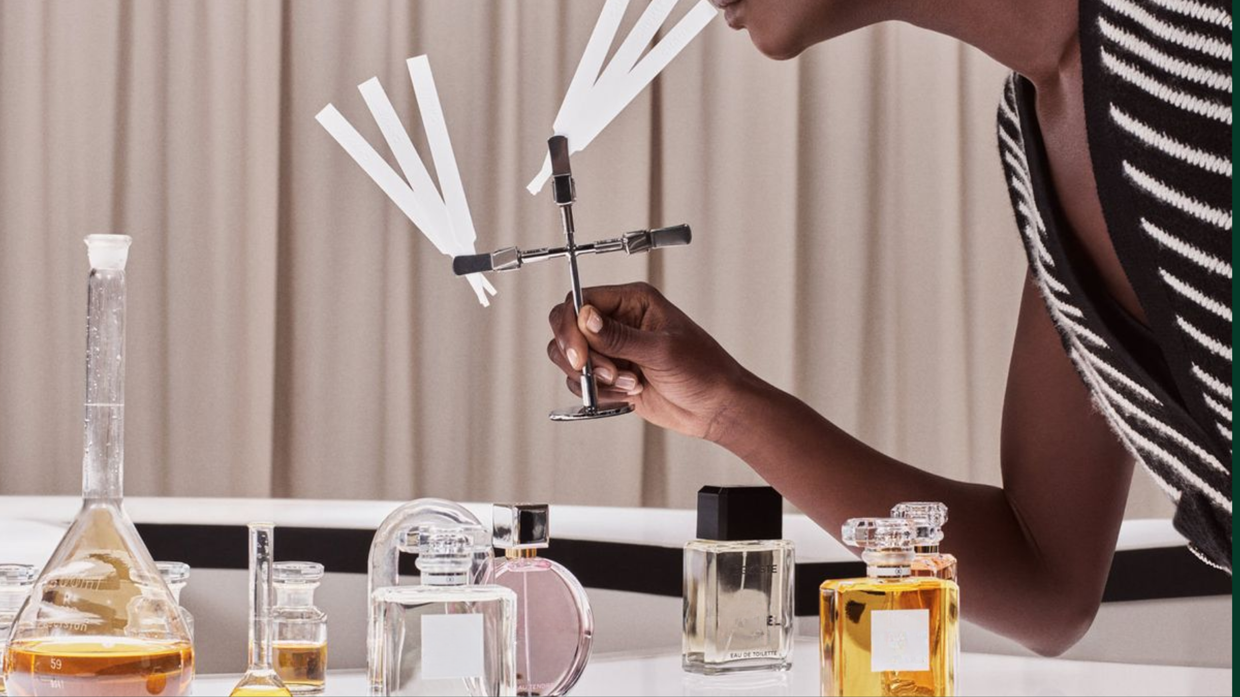 Person performing a scientific experiment with laboratory glassware and a windmill model in a laboratory setting.