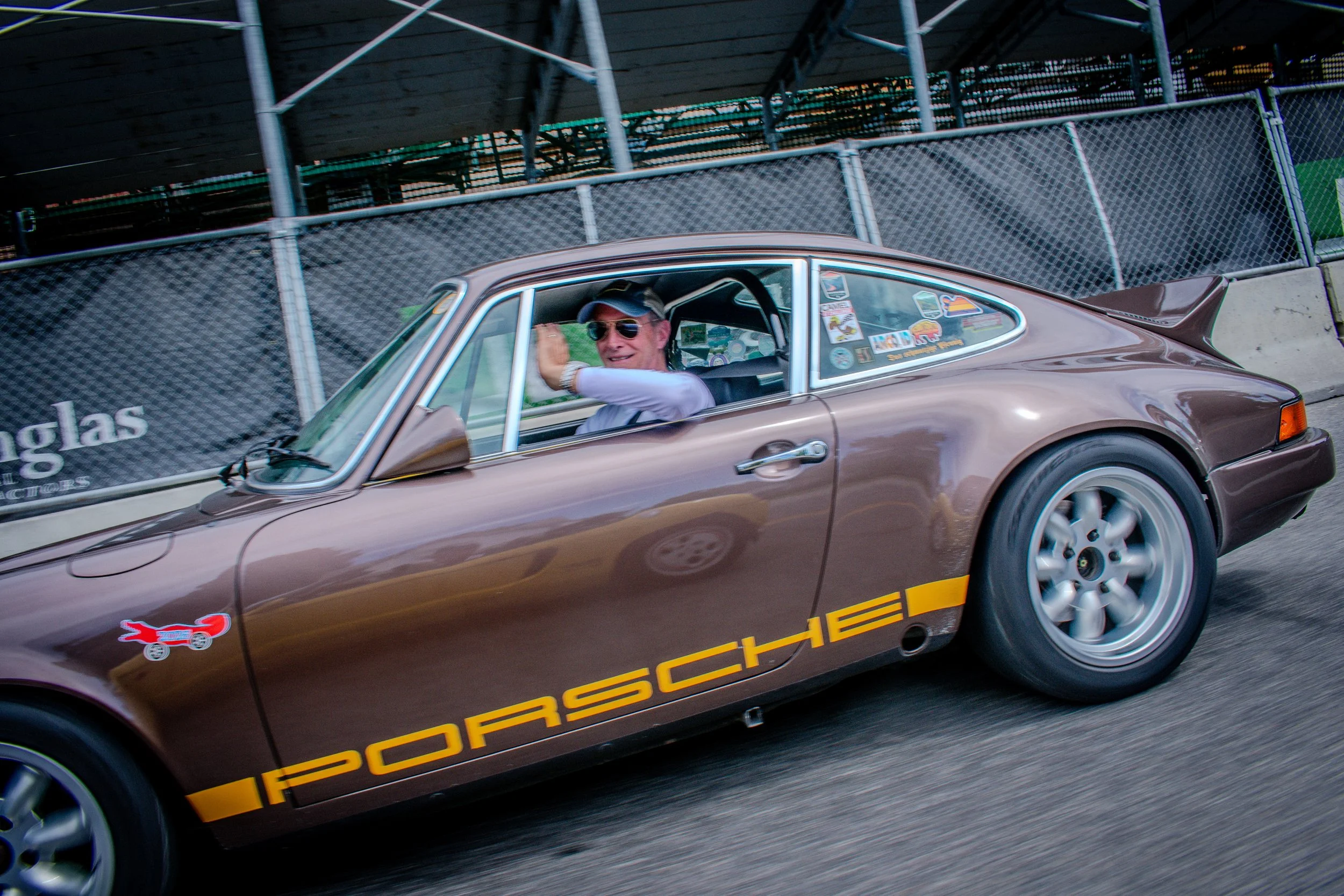 Brown classic Porsche 911 with Porsche script on the street in Bozeman