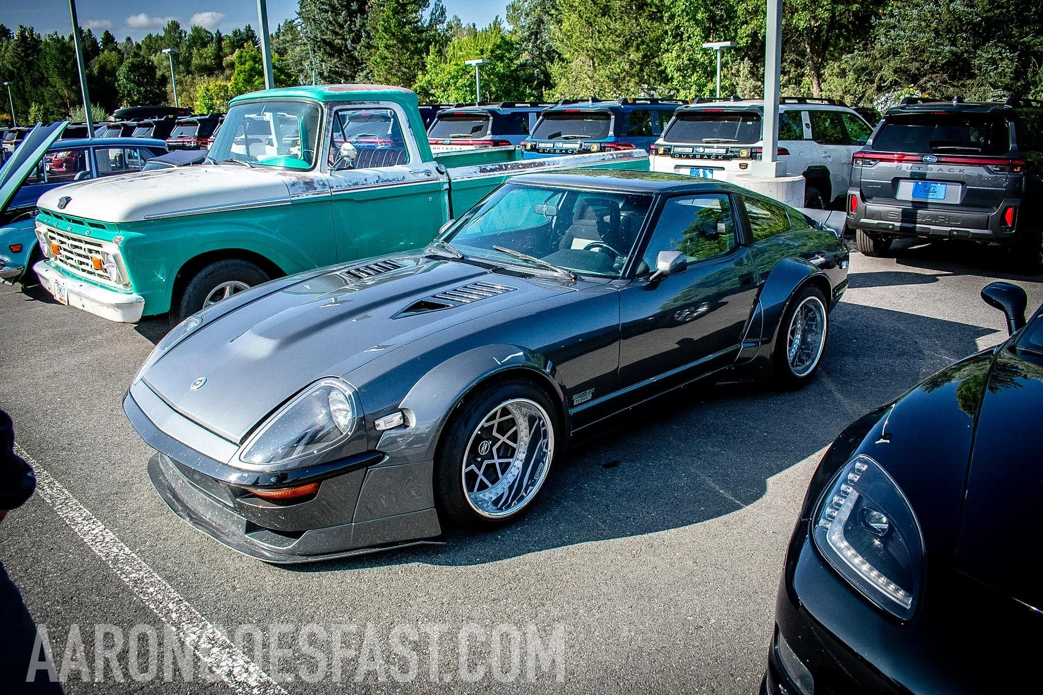 Gray Datsun 240Z beside a teal classic pickup at Ressler Cars & Coffee
