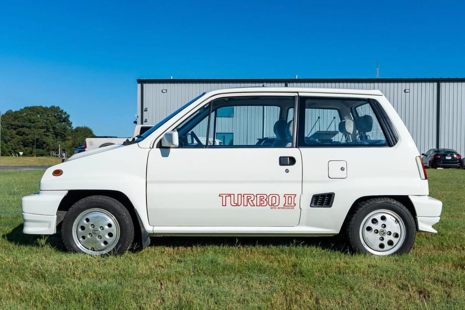 Side profile of the white 1984 Honda City Turbo II with red Turbo II door graphics