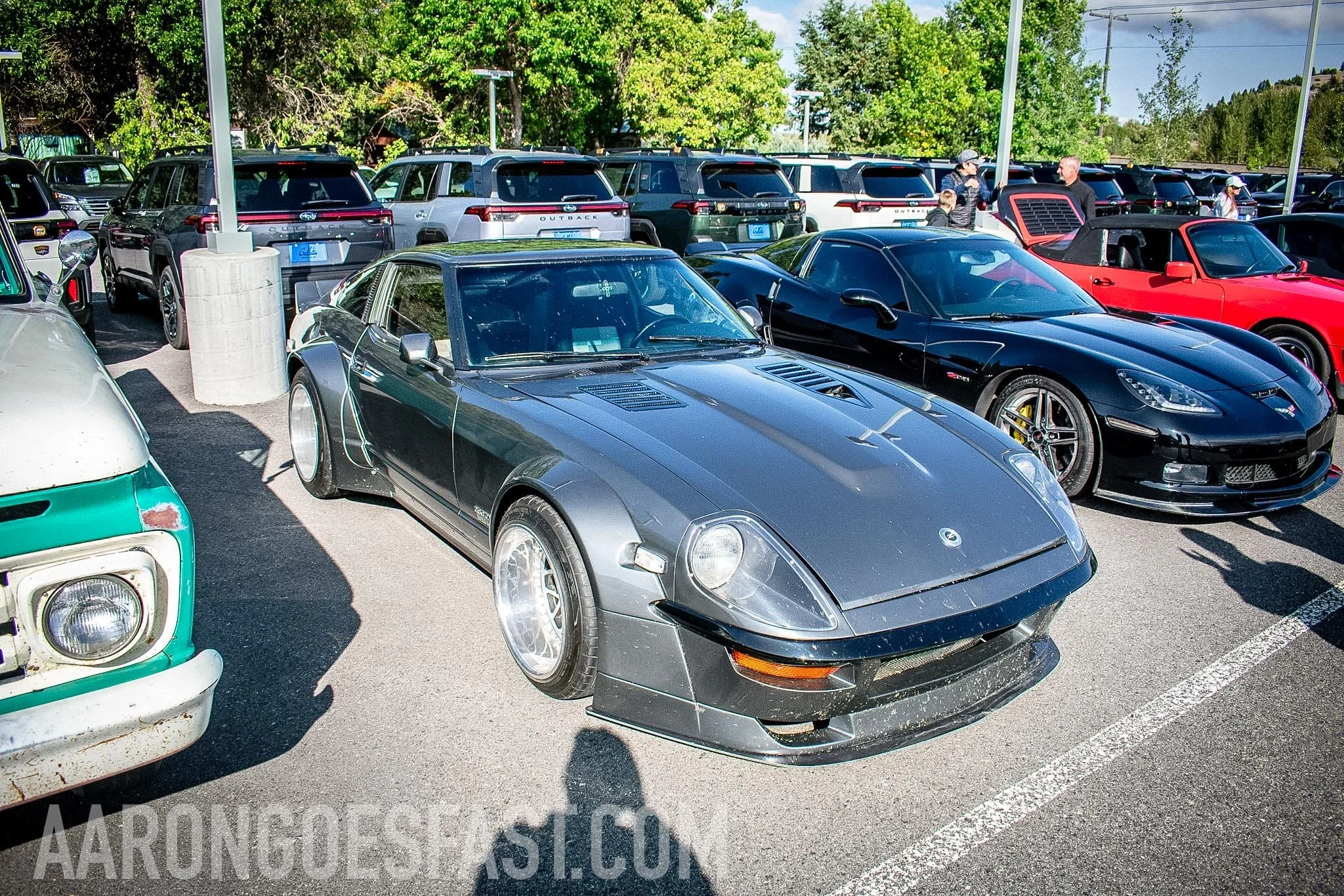 Gray Datsun Z car beside a black Porsche at Ressler Cars & Coffee